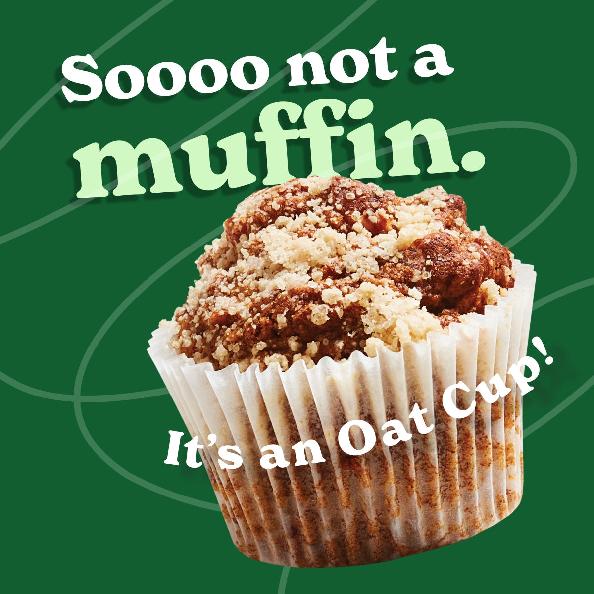 A baked oat cup with a crumbly topping in a white paper liner is featured against a green background. White and light green bold text reads, 'Soooo not a muffin. It’s an Oat Cup!' Smaller oat cup pieces are scattered around the image.